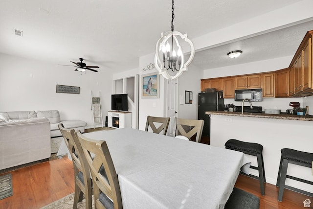462 W 1490 N Unit 102, Logan, UT 84341 - dining space with a chandelier, dark wood-style floors, and ceiling fan