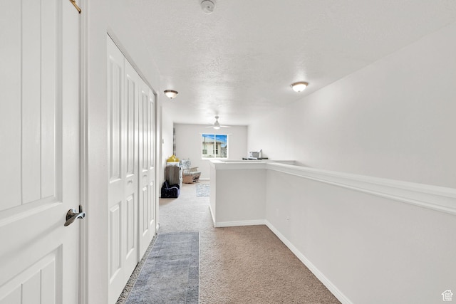 462 W 1490 N Unit 102, Logan, UT 84341 - corridor featuring carpet floors, a textured ceiling, and baseboards