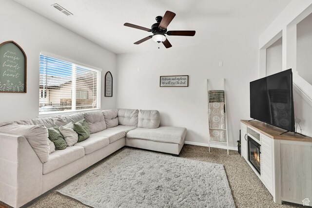 462 W 1490 N Unit 102, Logan, UT 84341 - living room with carpet floors, ceiling fan, a glass covered fireplace, and baseboards