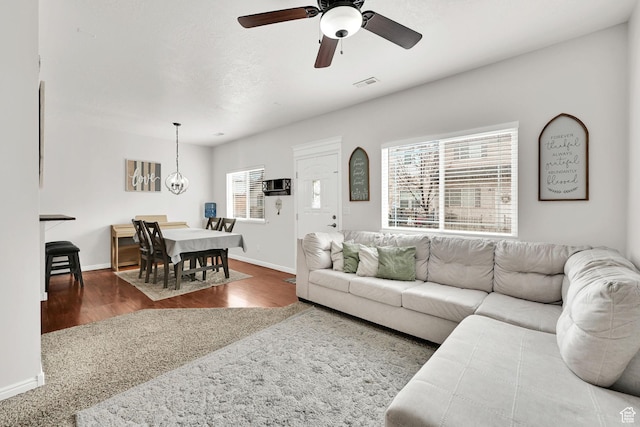 462 W 1490 N Unit 102, Logan, UT 84341 - living room featuring baseboards, wood finished floors, a ceiling fan, and a chandelier