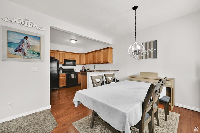 462 W 1490 N Unit 102, Logan, UT 84341 - dining space with a chandelier, baseboards, and dark wood-type flooring