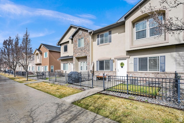 462 W 1490 N Unit 102, Logan, UT 84341 - townhome / multi-family property featuring stucco siding, a residential view, and stone siding