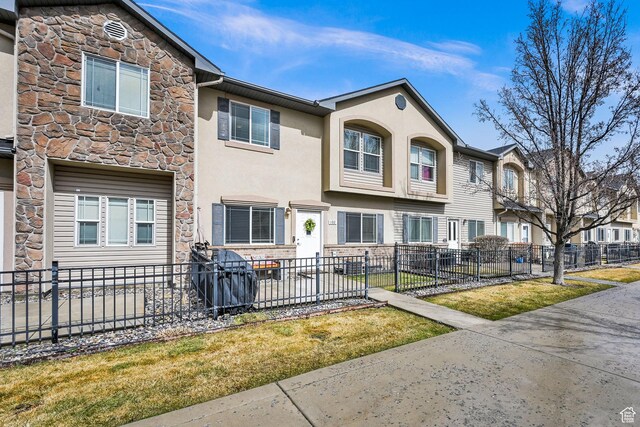 462 W 1490 N Unit 102, Logan, UT 84341 - view of property with stone siding, fence, stucco siding, and a residential view