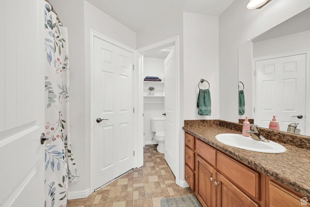 462 W 1490 N Unit 102, Logan, UT 84341 - bathroom featuring toilet, vanity, baseboards, and tile patterned floors