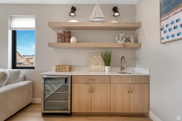 5401 S Aquamarine Ln E, St George, UT 84790 - bar featuring baseboards, indoor bar, wine cooler, light wood-style floors, and a sink
