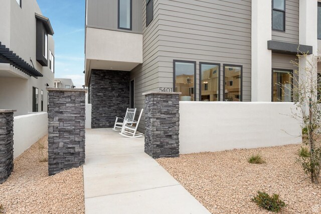 5401 S Aquamarine Ln E, St George, UT 84790 - doorway to property with stone siding and covered porch