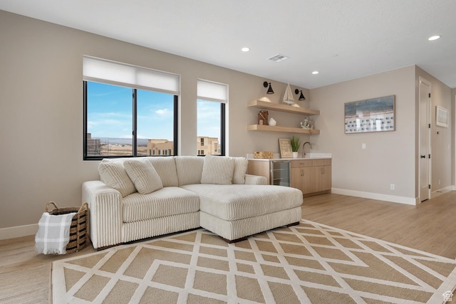 5401 S Aquamarine Ln E, St George, UT 84790 - living room featuring visible vents, recessed lighting, indoor wet bar, wine cooler, and light wood-type flooring