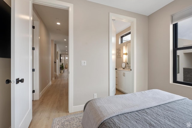 5401 S Aquamarine Ln E, St George, UT 84790 - bedroom with recessed lighting, connected bathroom, baseboards, and light wood-style floors