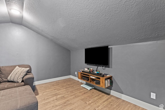 763 E 1200 S, Hyrum, UT 84319 - living area with a textured ceiling, lofted ceiling, baseboards, and wood finished floors