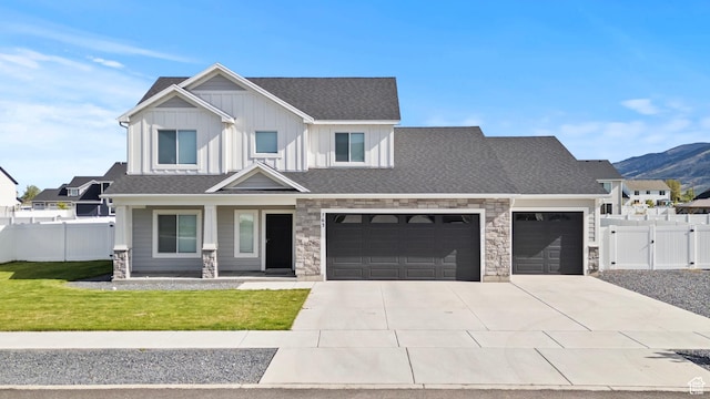 763 E 1200 S, Hyrum, UT 84319 - view of front of property featuring stone siding, driveway, an attached garage, a porch, and board and batten siding