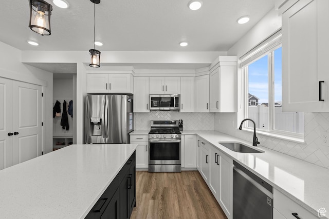763 E 1200 S, Hyrum, UT 84319 - kitchen featuring appliances with stainless steel finishes, a sink, white cabinets, light stone counters, and recessed lighting