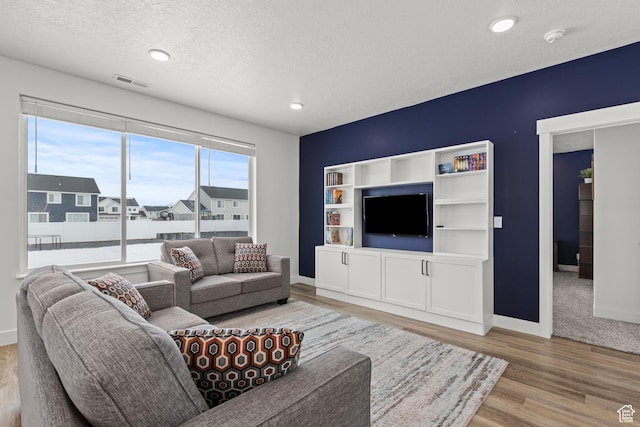 763 E 1200 S, Hyrum, UT 84319 - living room with light wood-type flooring, baseboards, a textured ceiling, and recessed lighting