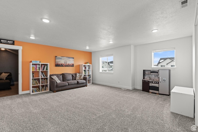 763 E 1200 S, Hyrum, UT 84319 - carpeted living area featuring a textured ceiling, baseboards, and recessed lighting