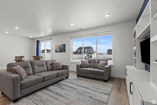 763 E 1200 S, Hyrum, UT 84319 - living room featuring wood finished floors, recessed lighting, a textured ceiling, and baseboards