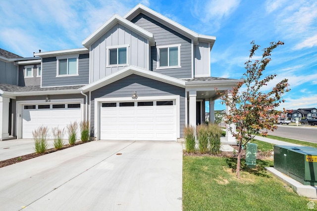 view of front of home with board and batten siding, concrete driveway, and an attached garage