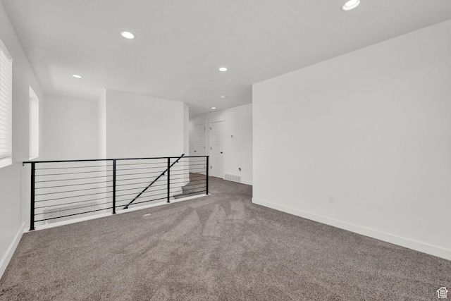 carpeted empty room with recessed lighting, visible vents, and baseboards