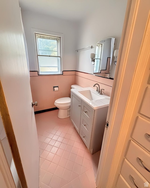 175 E 700 N, Logan, UT 84321 - bathroom featuring tile patterned floors, toilet, wainscoting, and vanity