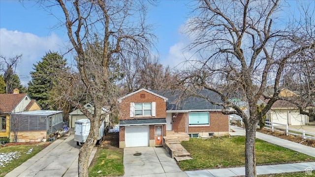 175 E 700 N, Logan, UT 84321 - view of front facade featuring a front yard, brick siding, concrete driveway, and an attached garage