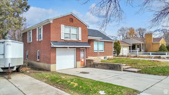 175 E 700 N, Logan, UT 84321 - view of front facade with brick siding, concrete driveway, an attached garage, and fence