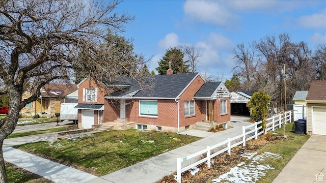 175 E 700 N, Logan, UT 84321 - view of front of property with brick siding, a front lawn, fence, concrete driveway, and a garage