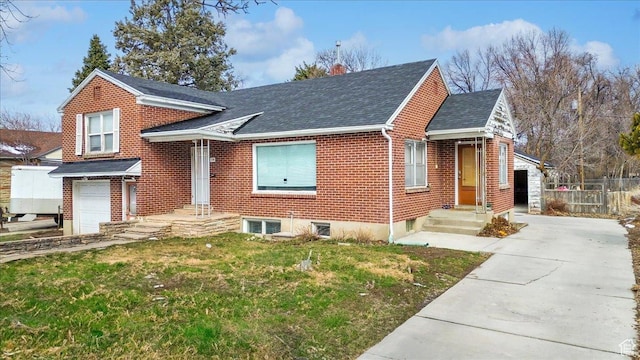 175 E 700 N, Logan, UT 84321 - view of front facade with brick siding, a front lawn, fence, roof with shingles, and an attached garage