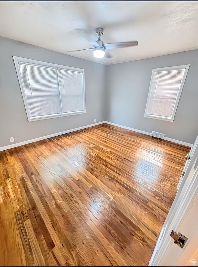 175 E 700 N, Logan, UT 84321 - spare room with baseboards, wood finished floors, visible vents, and ceiling fan