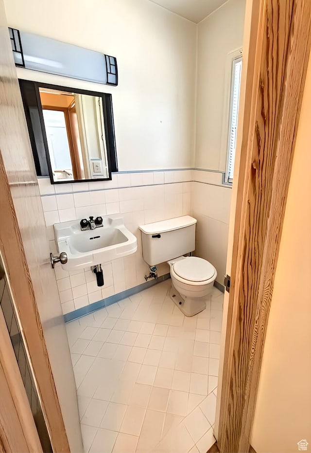 175 E 700 N, Logan, UT 84321 - bathroom featuring tile walls, toilet, tile patterned floors, and a sink