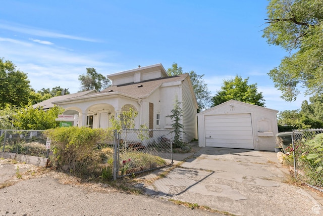 661 E 2735 S, Ogden, UT 84403 - view of front facade with a fenced front yard, driveway, an outbuilding, a garage, and stucco siding