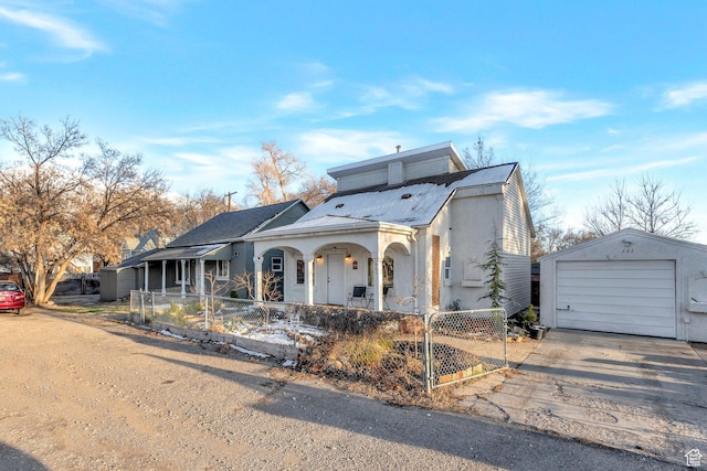view of front of home featuring an outbuilding, fence, driveway, covered porch, and a garage