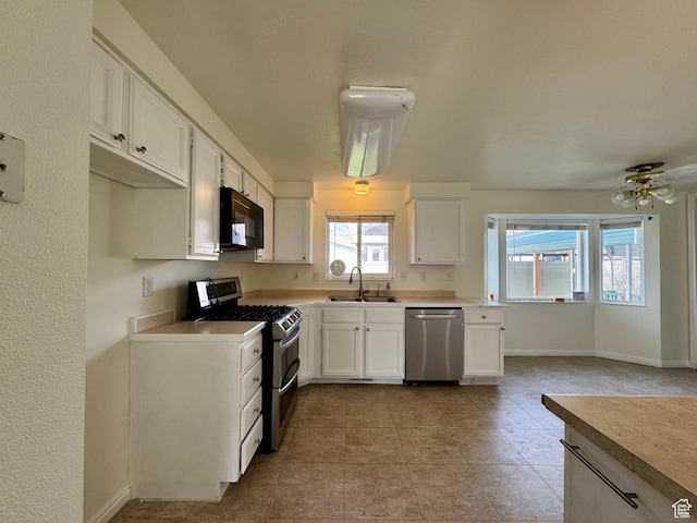 315 S 300 W, Santaquin, UT 84655 - kitchen featuring baseboards, a sink, white cabinets, and stainless steel appliances
