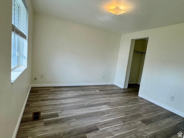 315 S 300 W, Santaquin, UT 84655 - unfurnished bedroom featuring dark wood-type flooring, a closet, baseboards, and visible vents