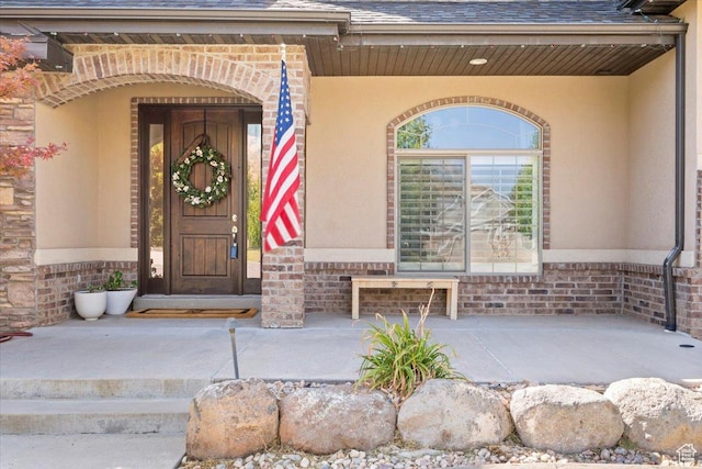 1336 S 2650 E, Springville, UT 84663 - view of exterior entry featuring brick siding, roof with shingles, and stucco siding