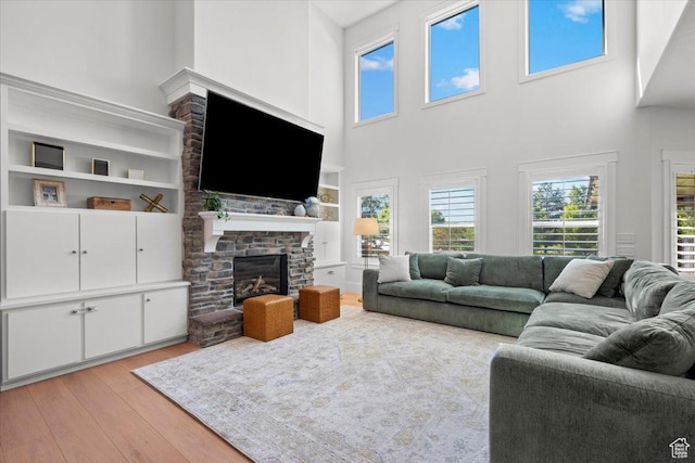 1336 S 2650 E, Springville, UT 84663 - living area featuring a stone fireplace and light wood-type flooring