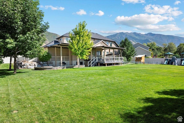1336 S 2650 E, Springville, UT 84663 - rear view of house featuring a playground, a lawn, a deck with mountain view, and fence