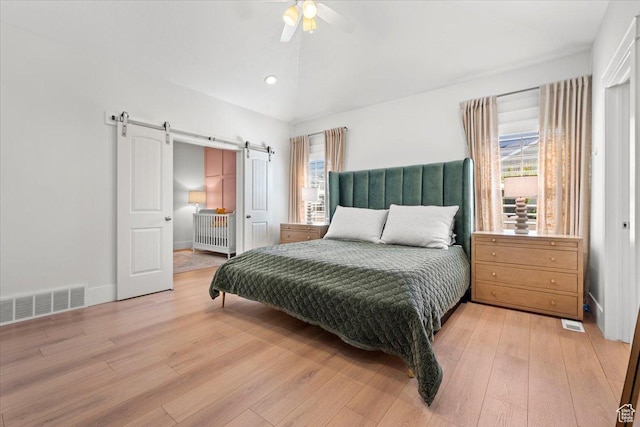 1336 S 2650 E, Springville, UT 84663 - bedroom with light wood finished floors, visible vents, baseboards, a barn door, and vaulted ceiling