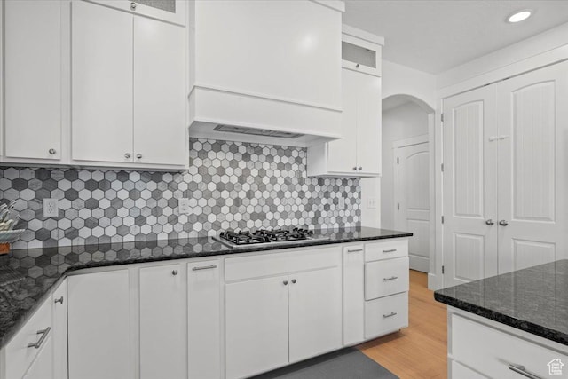 1336 S 2650 E, Springville, UT 84663 - kitchen featuring light wood-style flooring, white cabinetry, dark stone counters, stainless steel gas stovetop, and custom exhaust hood