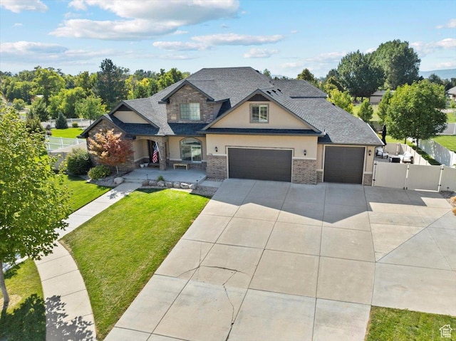 1336 S 2650 E, Springville, UT 84663 - craftsman-style home featuring a front lawn, fence, stucco siding, driveway, and a gate