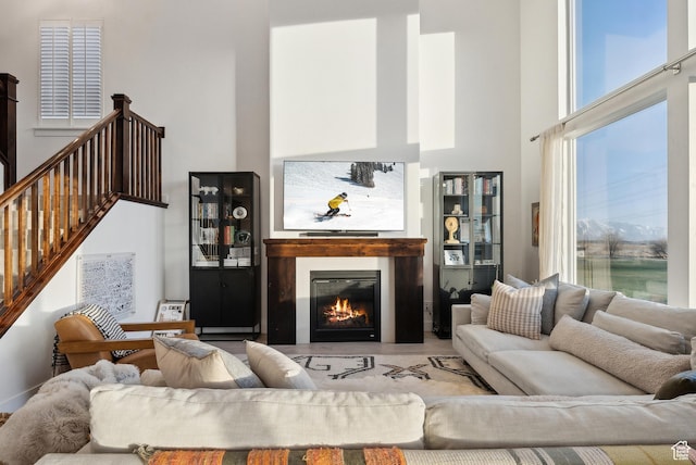 2101 W 980 S, Orem, UT 84059 - living room with a glass covered fireplace, a towering ceiling, and stairs
