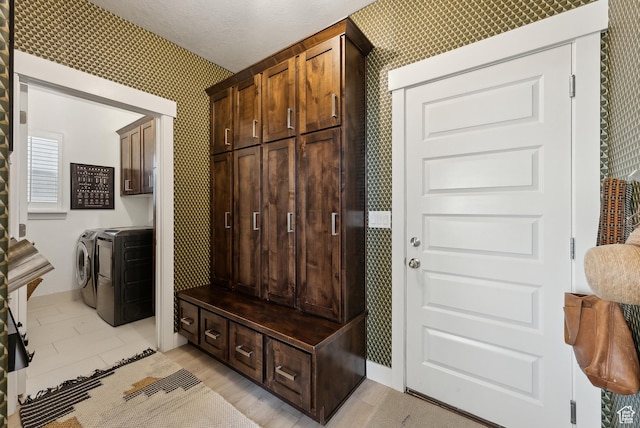 2101 W 980 S, Orem, UT 84059 - mudroom featuring wallpapered walls, washing machine and dryer, baseboards, and a textured ceiling