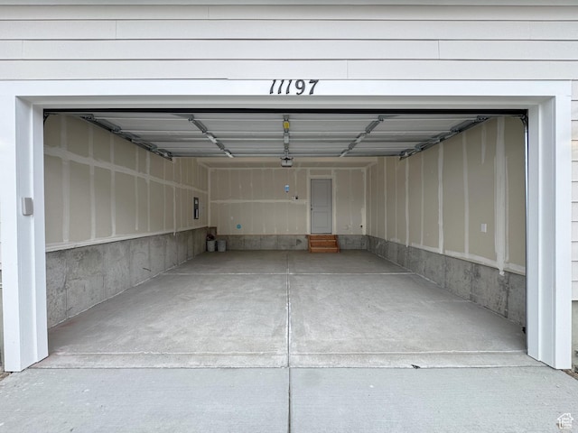 garage featuring a garage door opener and concrete driveway
