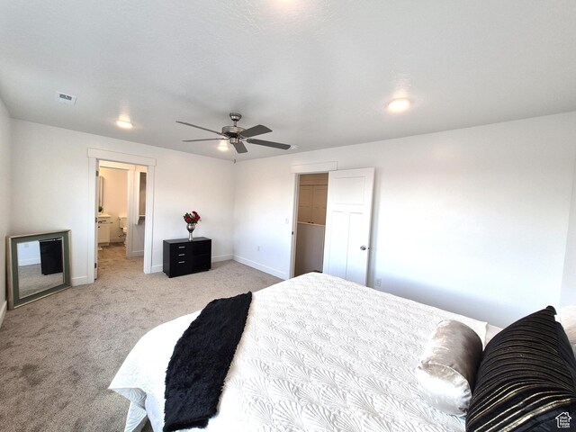 bedroom featuring visible vents, baseboards, light colored carpet, and a ceiling fan