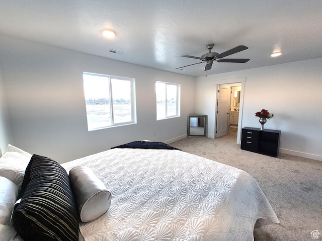 bedroom featuring visible vents, light carpet, baseboards, and ceiling fan