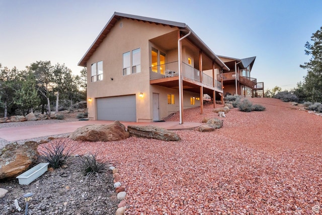 1617 N Mount Zion Dr, Apple Valley, UT 84737 - exterior space featuring driveway, stairs, a garage, and stucco siding