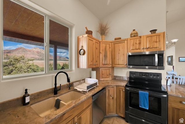 1617 N Mount Zion Dr, Apple Valley, UT 84737 - kitchen with light tile patterned flooring, vaulted ceiling, a sink, light stone countertops, and appliances with stainless steel finishes