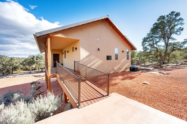 1617 N Mount Zion Dr, Apple Valley, UT 84737 - back of house featuring cooling unit and stucco siding