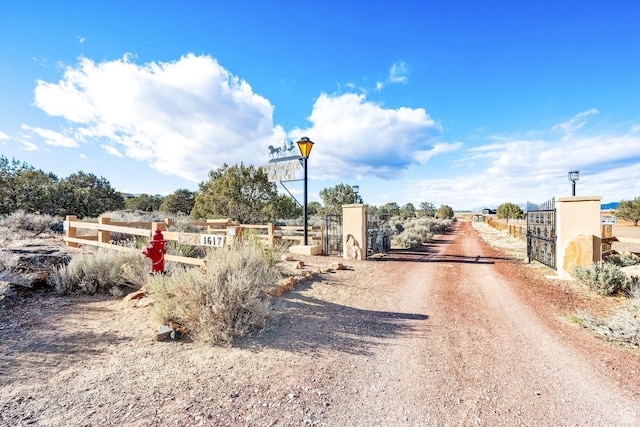 1617 N Mount Zion Dr, Apple Valley, UT 84737 - view of street with a gated entry, a gate, and dirt driveway