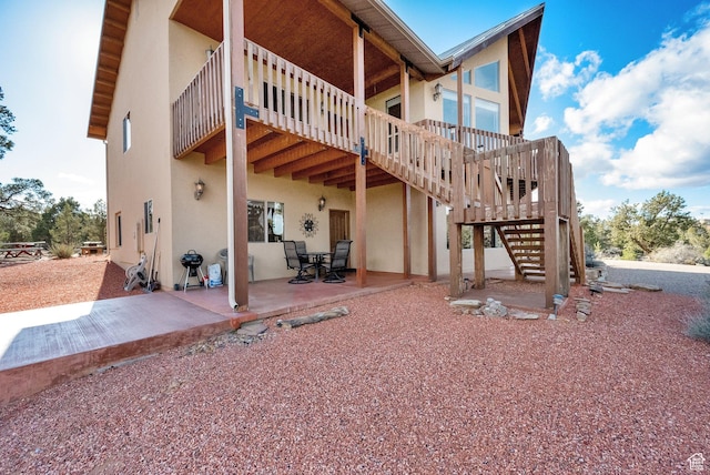1617 N Mount Zion Dr, Apple Valley, UT 84737 - rear view of house with stucco siding, stairs, and a patio area