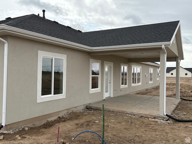 2861 N 3475 W Unit 15, Plain City, UT 84404 - back of property with a shingled roof, a patio, and stucco siding