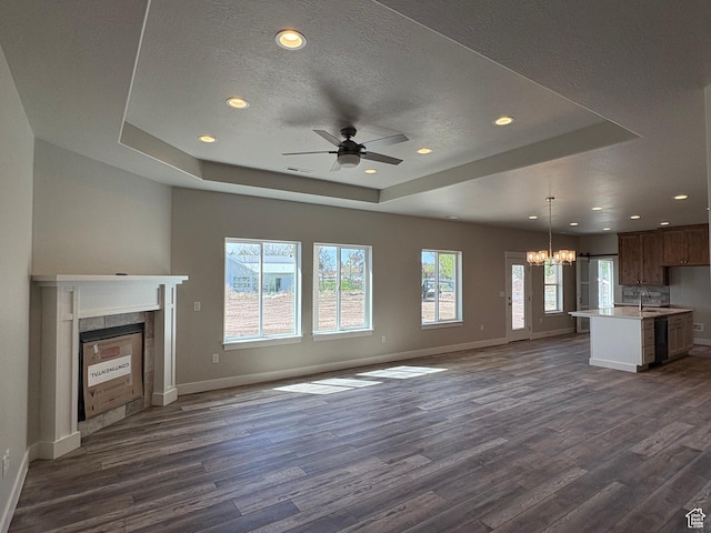2861 N 3475 W Unit 15, Plain City, UT 84404 - unfurnished living room with a sink, a raised ceiling, baseboards, dark wood-type flooring, and recessed lighting