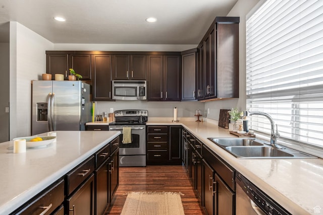 4712 W S Jordan Pkwy S, South Jordan, UT 84009 - kitchen featuring dark wood finished floors, dark brown cabinetry, light countertops, appliances with stainless steel finishes, and a sink